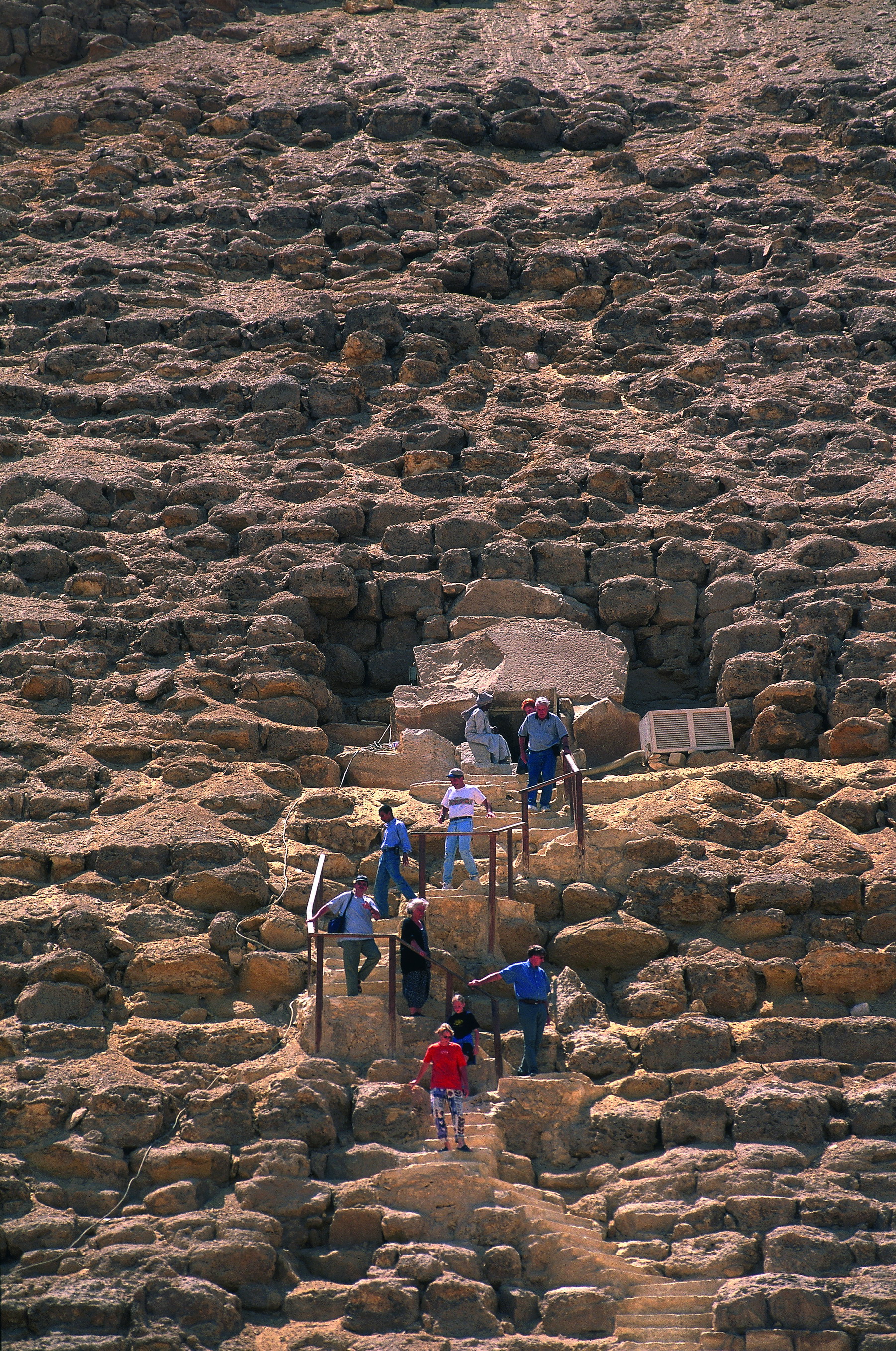 Visiteurs sur les assises de pierre d’une pyramide de Gizeh