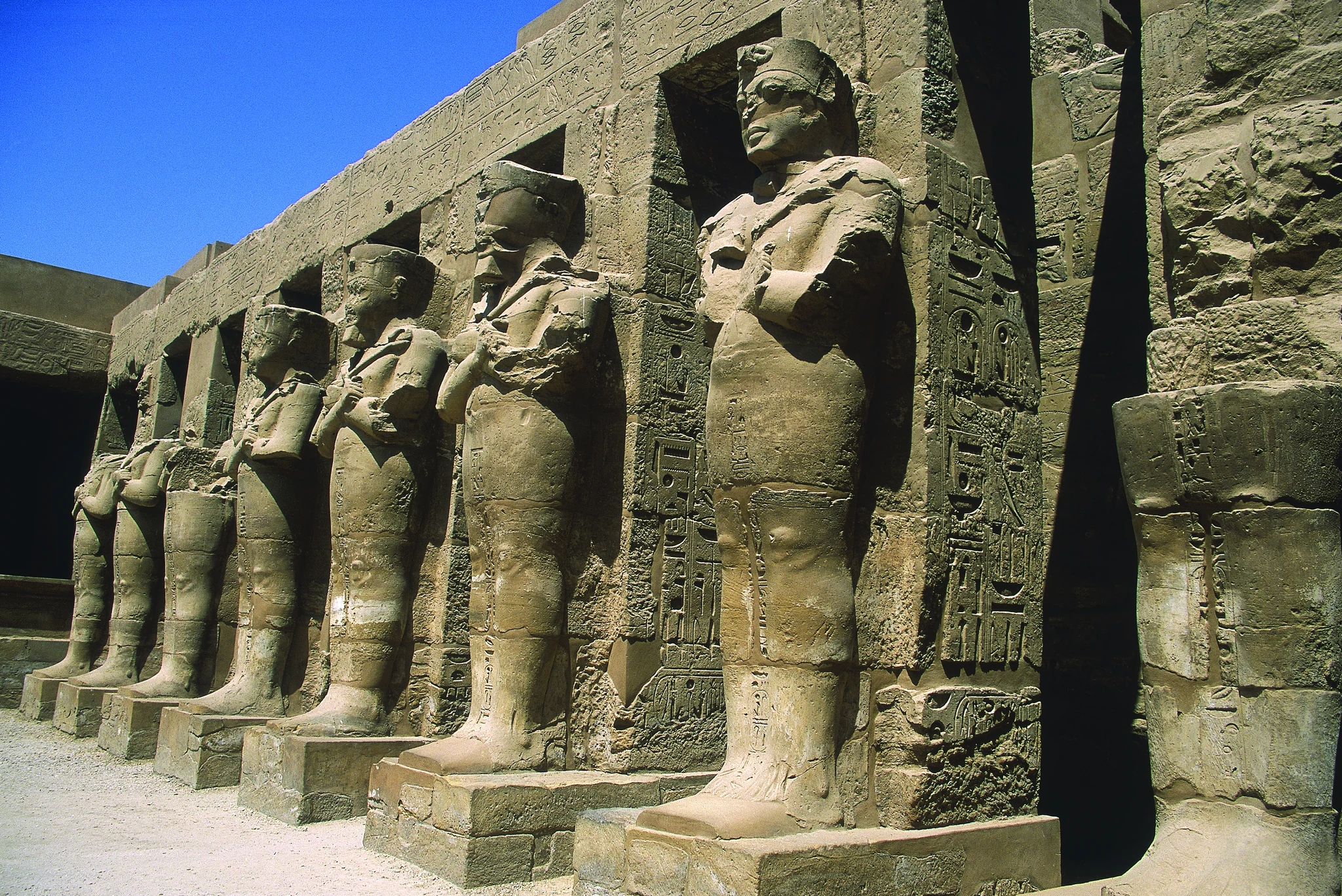 Les statues royales adossées aux piliers du temple de Ramsès III à Karnak.